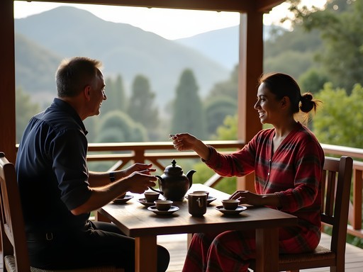 Local hotel owner in Bandipur sharing traditional Nepalese tea preparation with guests on wooden terrace