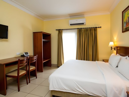 Standard business room at Alvino Hotel in Ganta showing air conditioning and desk setup