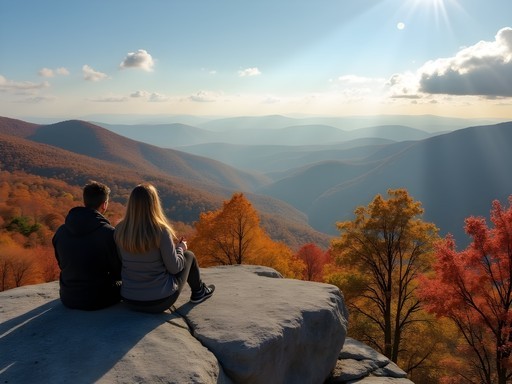 Couple enjoying panoramic views from the summit of Looking Glass Rock in fall
