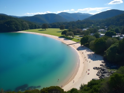 Sheltered horseshoe-shaped Anzac Bay with calm waters and families enjoying beach