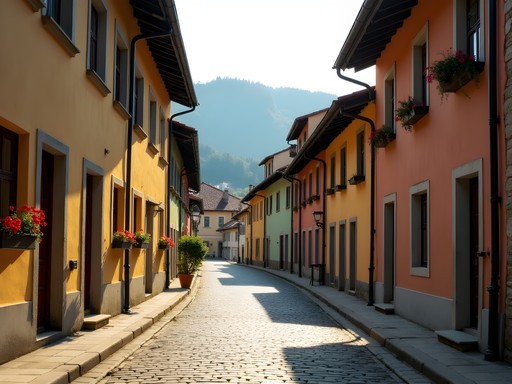 Early morning on empty cobblestone street in Brasov Old Town with colorful buildings and mountain backdrop