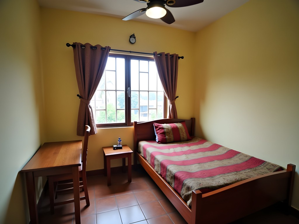 Simple but clean budget hotel room in Khulna with basic furnishings and local textiles