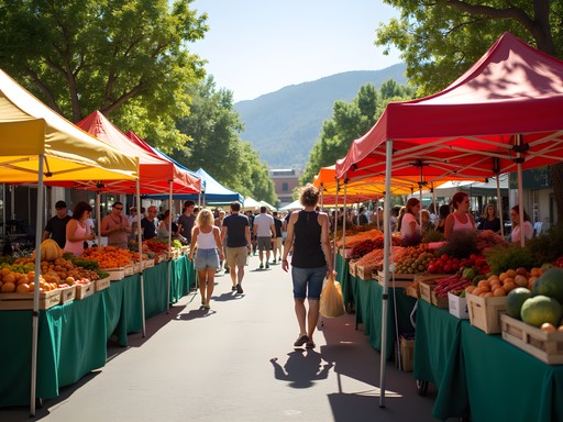 Colorful display of fresh local produce at Ogden Farmers Market with mountain backdrop