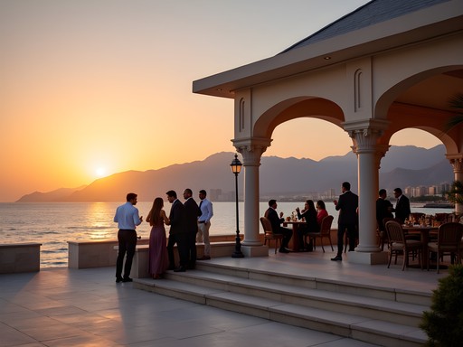 Business professionals networking at Al Bustan Palace Beach Pavilion during sunset in Muscat