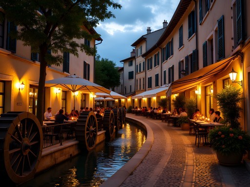 Atmospheric evening scene on Rue des Teinturiers with water wheels and café lights