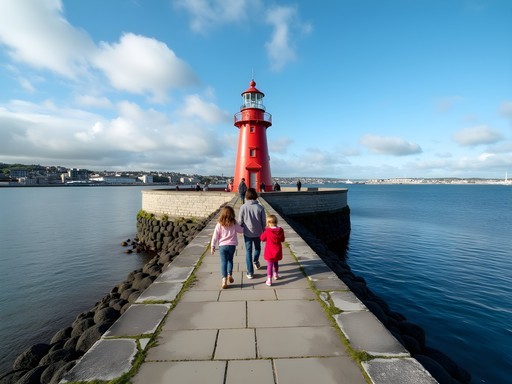 Family walking along Great South Wall toward red Poolbeg Lighthouse in Dublin Bay