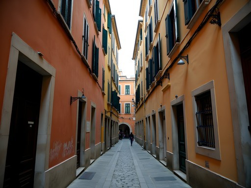 Narrow medieval caruggi alleyway in Genoa's historical center with laundry hanging between buildings