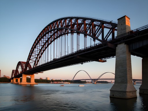 Historic Eads Bridge spanning Mississippi River with Gateway Arch in background