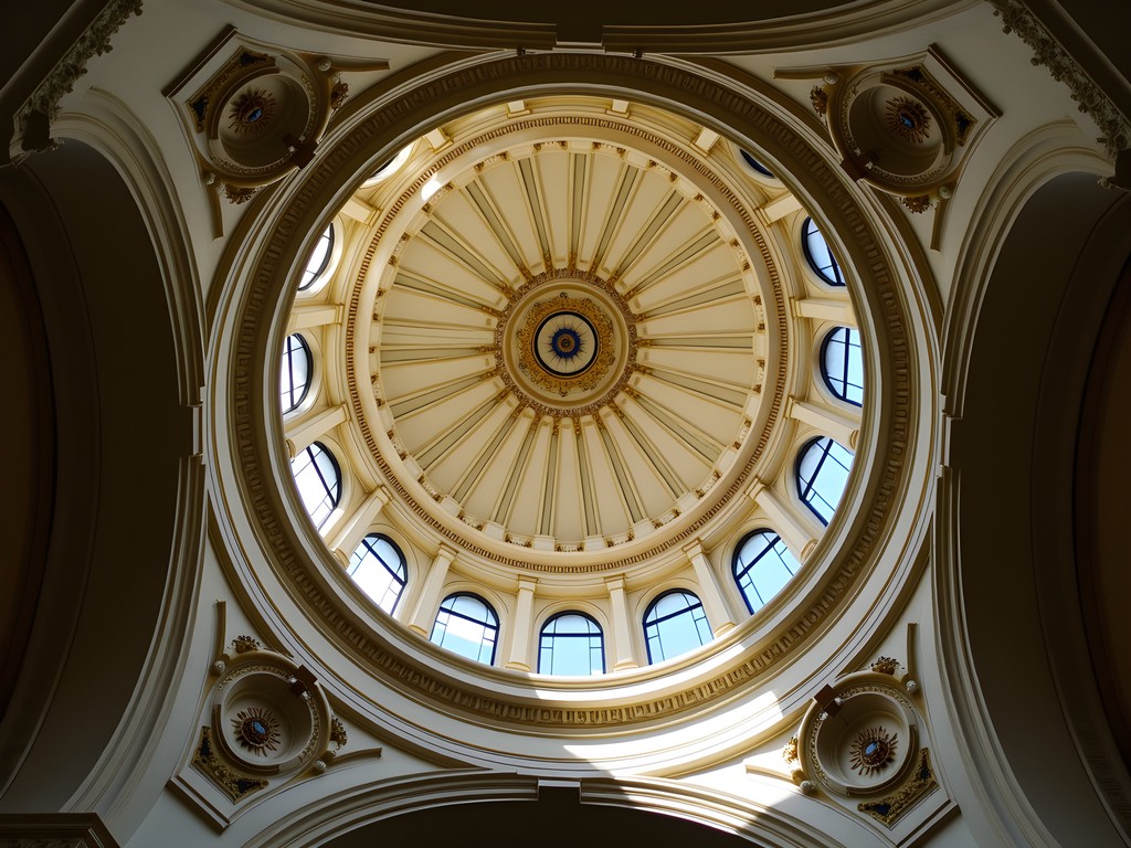 Ornate domed ceiling of Tuckerman Hall showing detailed plasterwork and stained glass