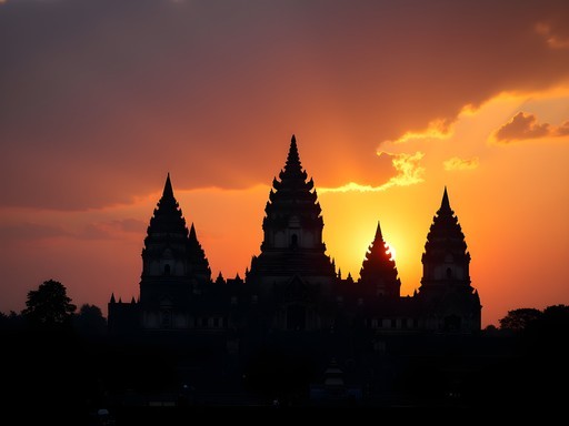 Prambanan temple spires silhouetted against dramatic orange sunset sky in Yogyakarta