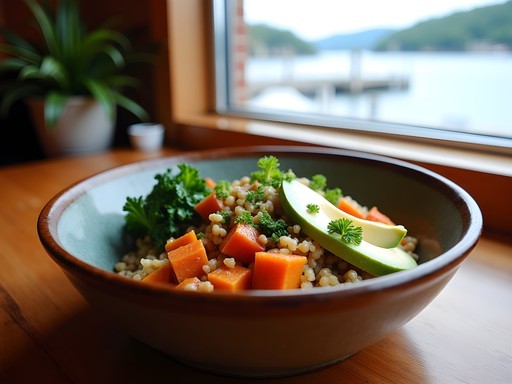 Colorful vegan Buddha bowl with view of Bar Harbor waterfront through restaurant window
