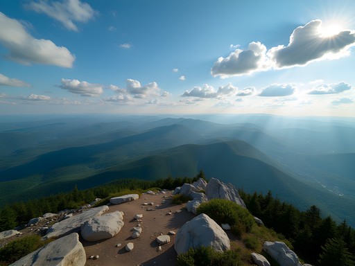 Panoramic view from Killington Peak summit showing Green Mountains and distant ranges across four states