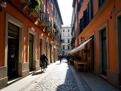 Narrow cobblestone street in Milan's Brera district with historic buildings and cafes