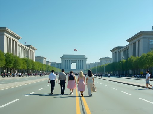 Tourists walking along a wide boulevard in Pyongyang with guides