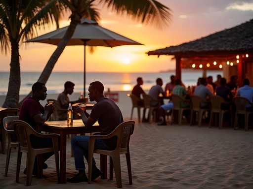 Evening social gathering along Bata's beachfront with locals enjoying sunset drinks